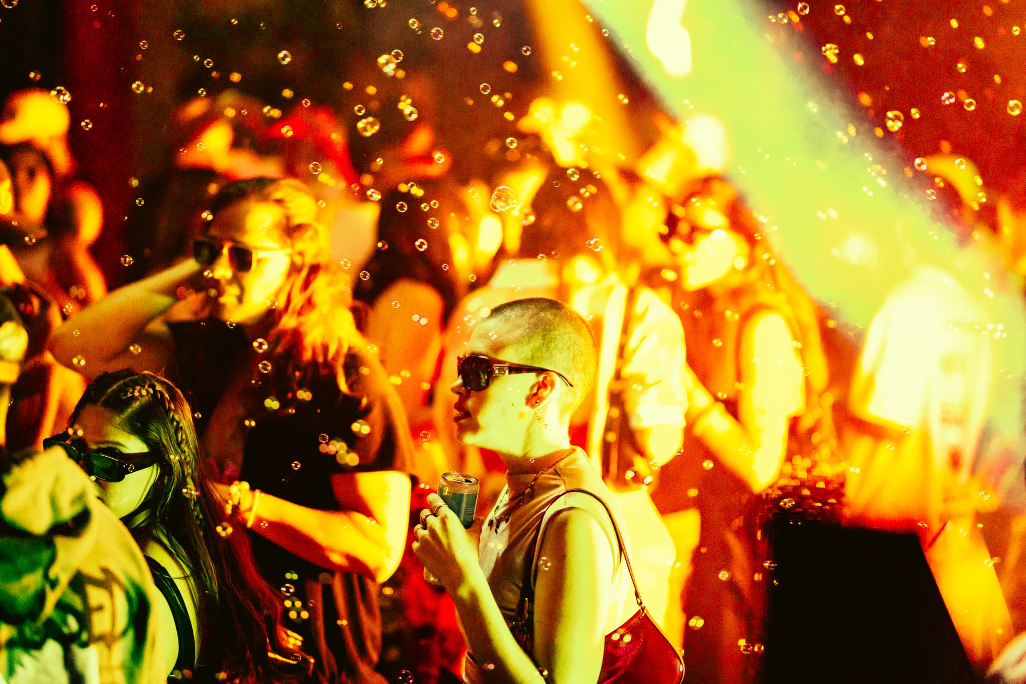 DJ working the decks seen from behind under deep red light